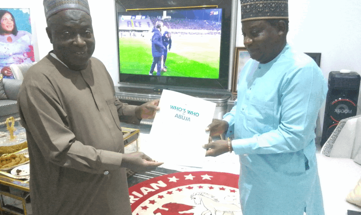 Award presentation at Who's Who Nigeria Hall of Fame Ltd, recognizing notable Nigerian individuals, with emphasis on contributions to Nigerian society and culture, featured in a formal indoor setting.